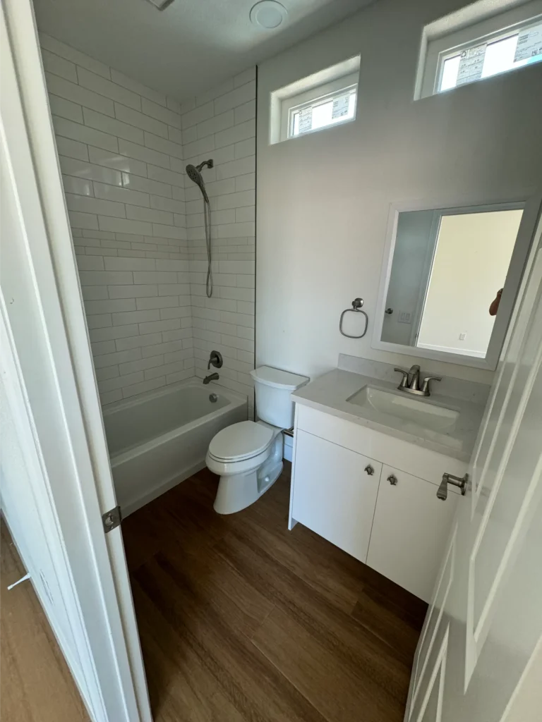 custom tile shower granite vanity and wood flooring installation