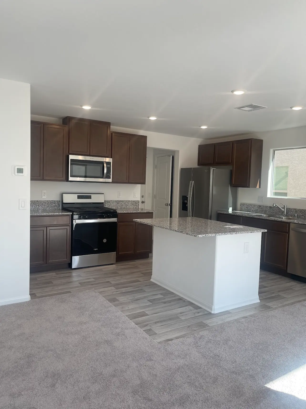 granite countertop kitchen renovation with laminate vinyl plank flooring